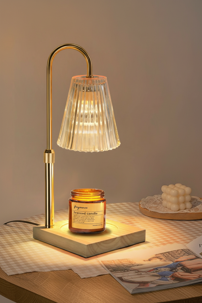 Vintage candle warmer lamp glass shade with amber glow and wooden base on oak side table